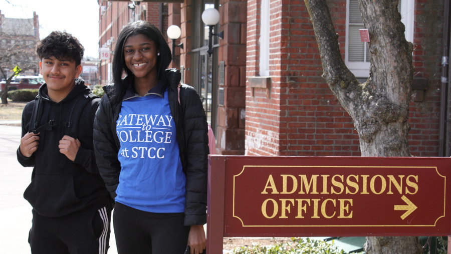 Gateway to College students with Gateway T-shirt next to Admissions Office sign