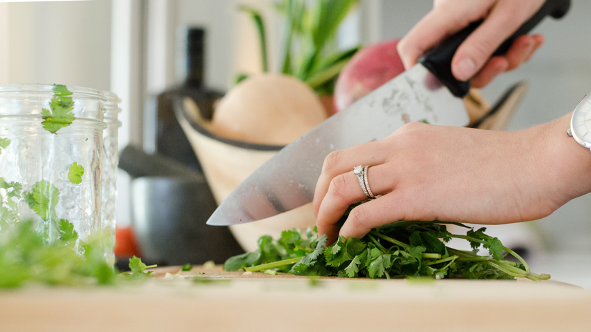 Chef's knife cutting cilantro