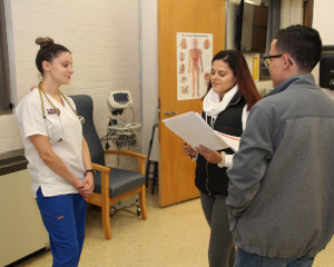 nurse speaking to two students