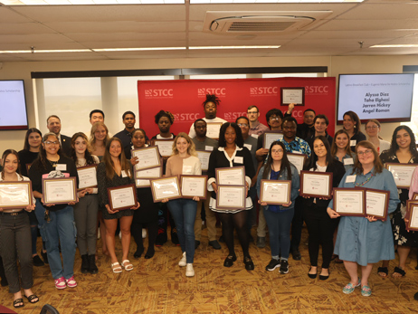 scholarship recipients holding certificates at 2025 Scholarship Luncheon