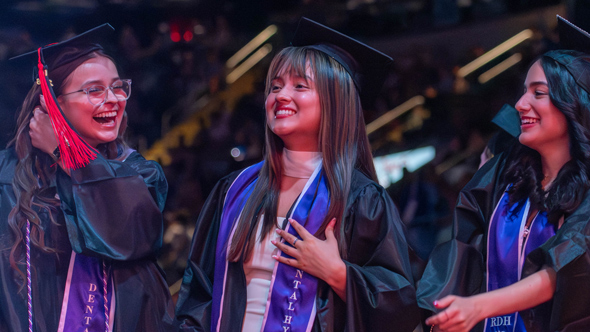 graduates walking in at commencement ceremony