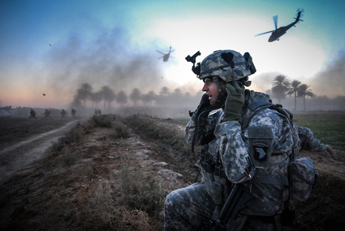 Ben Brody in uniform in Aphganistan with helicopters in distance