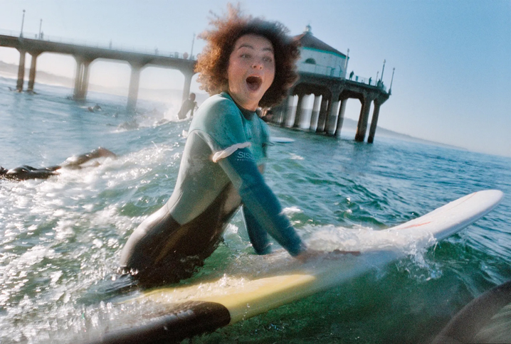 Surfer making a look of shock as they get wet