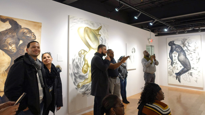 art aficionados enjoying Art and Soul exhibit