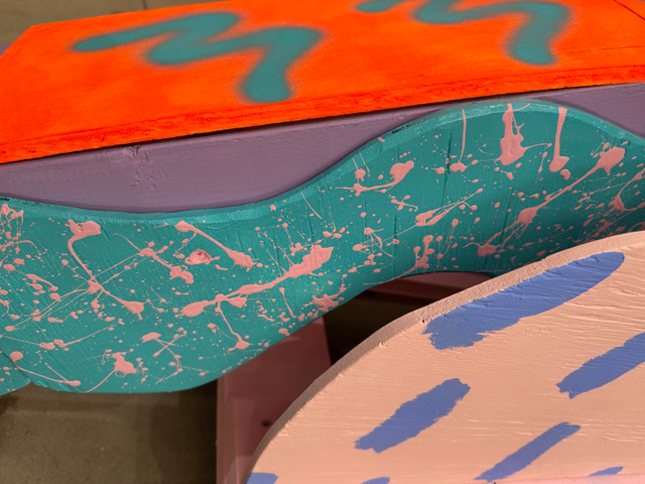wavy wood pieces colorfully painted with splatter and squiggles