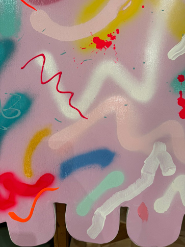 yellow background with many colored spray paint squiggles