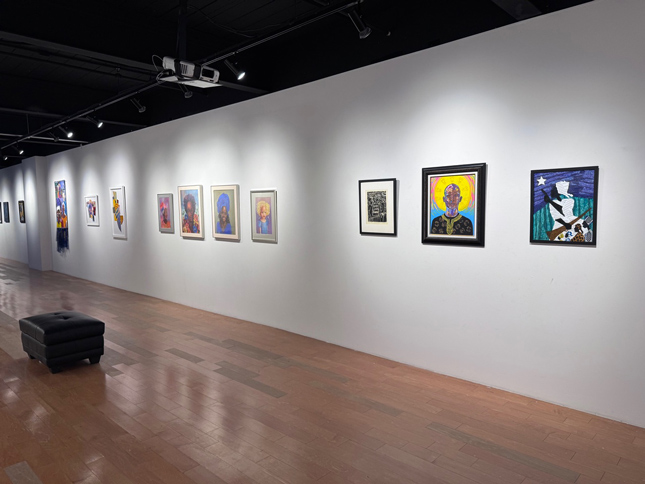 back wall of Where We At exhibit with many painted portraits of black women