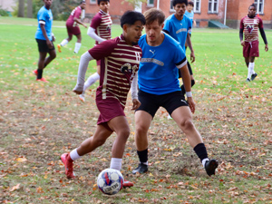 STCC men's soccer player dribbling around opponent