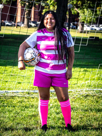 Eileen Velasquez holding soccer ball against chest