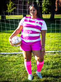 Cianna Barfield with soccer ball in front of net