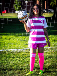 Byanka Cedrez holding a soccer ball indifferently as if it was alive yet harmless