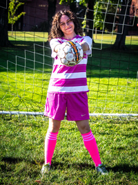 Keily Velez Reyes holding soccer ball stretched out front with two hands
