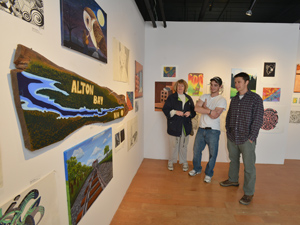 students and parent admiring student art showcase