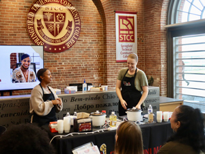 center for access services staff cooking in front of group of students