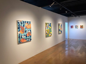 Donnabelle Casis Exhibit with paintings hung on gallery walls