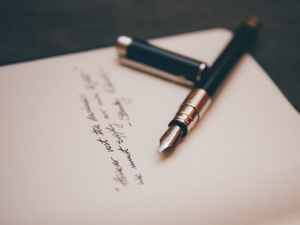 paper and pen with blurred text