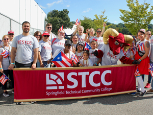 STCC community at the Puerto Rican Parade with STCC banner and Puerto Rican flags