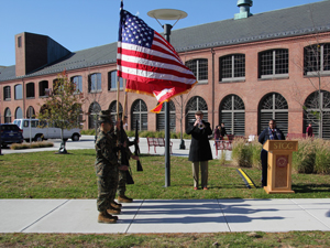 soldier carrying american flag at veteran's day event