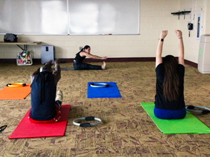 students stretching on yoga mats