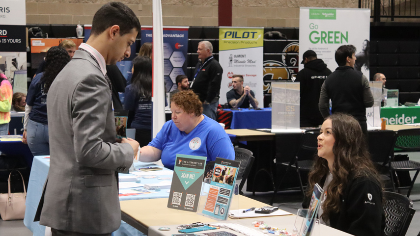 student speaking to recruiter at career fair