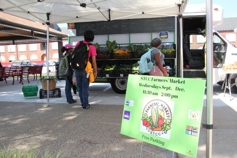 Entrance of Farmers' Market with Sign and Vegetable Stand