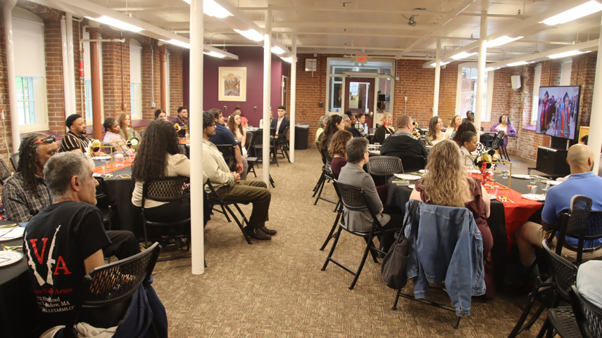 event with people watching large screen in Garvey Conference Room