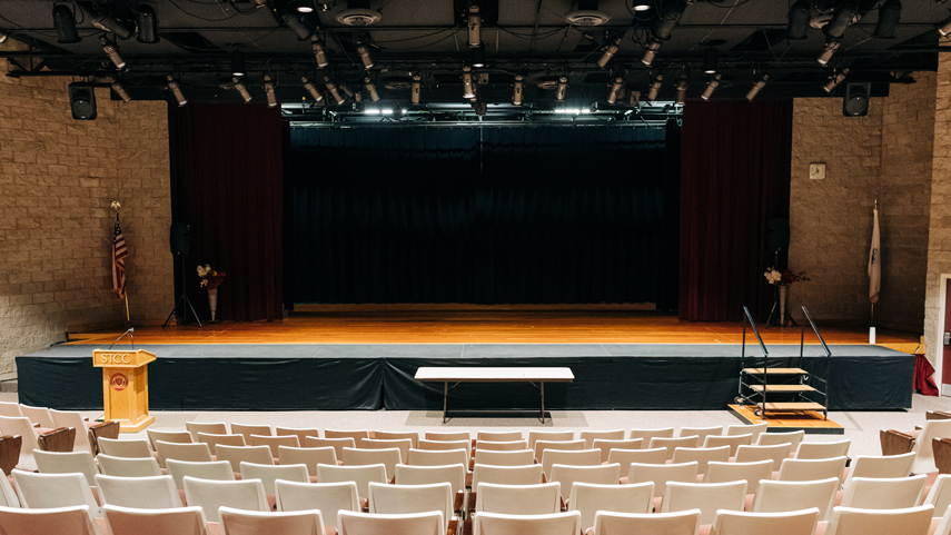 Auditorium with stage, lights, and seats