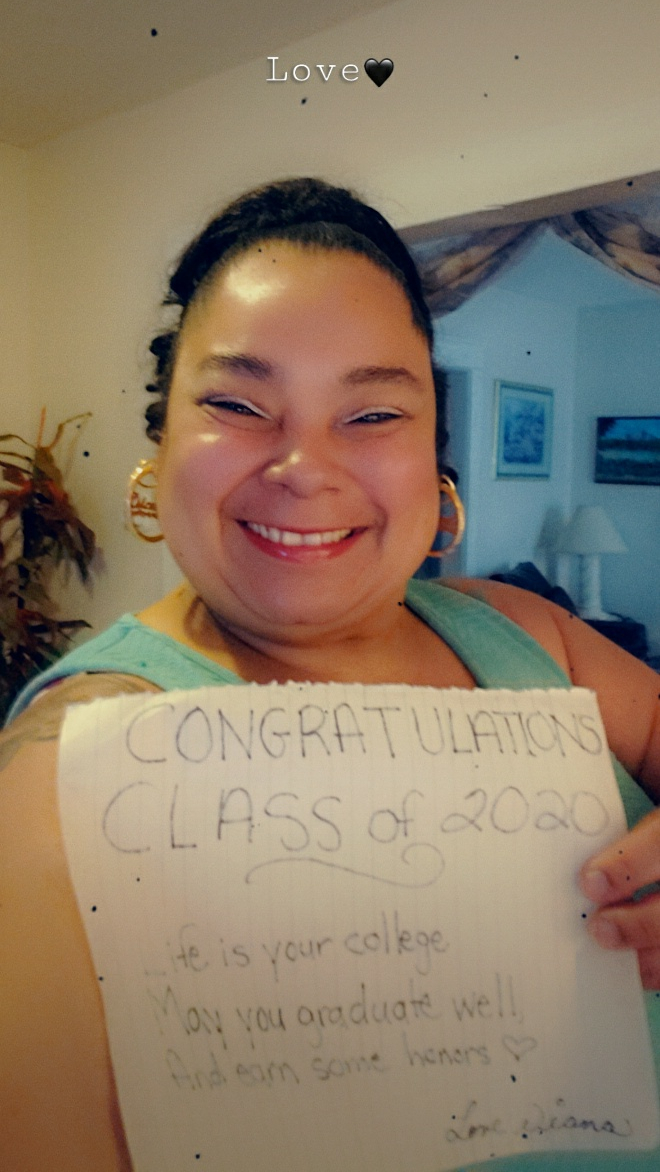 Diana holding a sign that reads congratulations class of 2020 Life is your college. May you graduate well and earn some honors