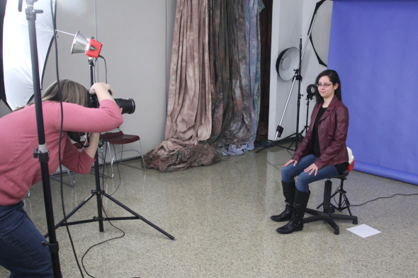 student photographing a student in studio