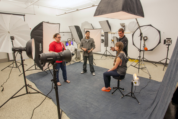 photography students in studio with cameras and lights