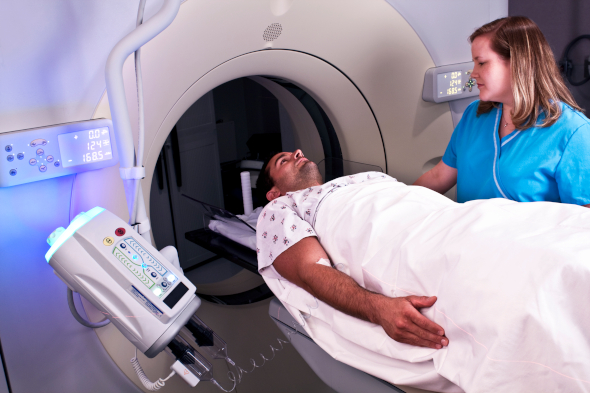 Technologist putting patient into MRI