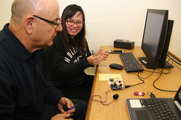 professor and student at computer with information technology hardware