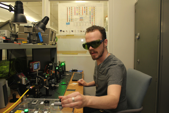 optics and photonics student working with machinery