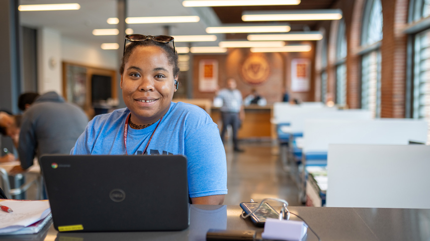 Student in Library on laptop