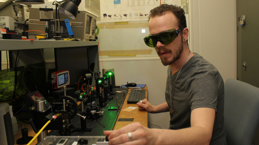 student at electrical board with protective glasses