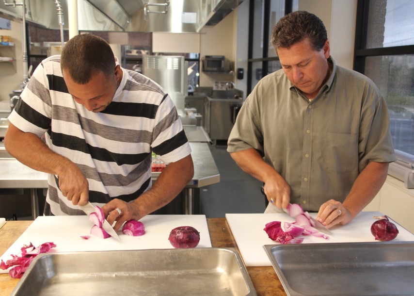 Trainees cut onions at Culinary Arts Institute