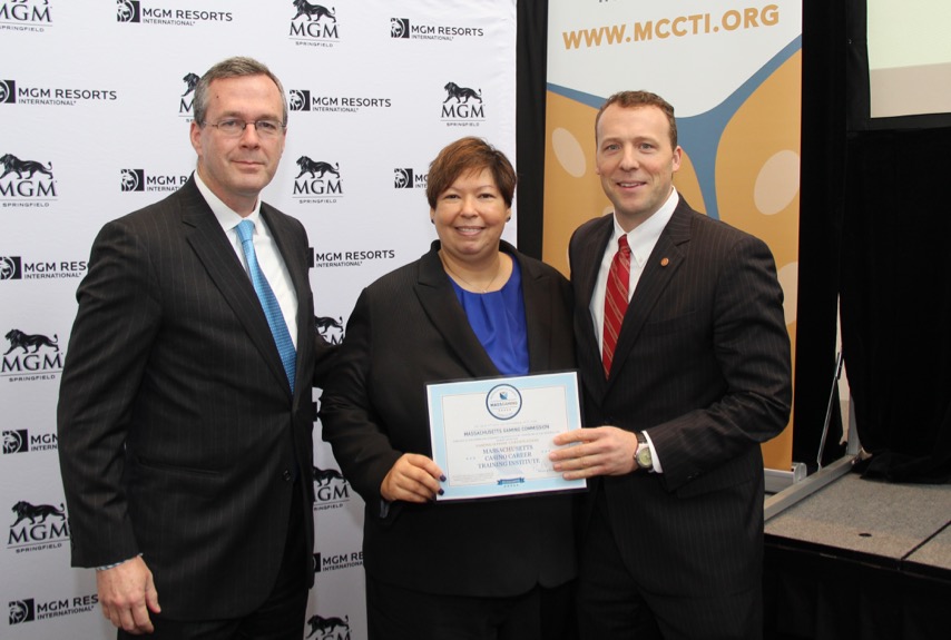  Massachusetts Gaming Commissioner Bruce Stebbins awards a gaming school certificate to HCC president Christina Royal and STCC president John B. Cook.