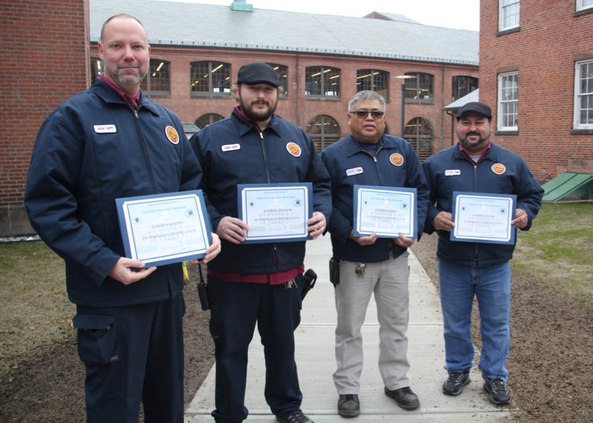 Four HVAC workers hold their certificates