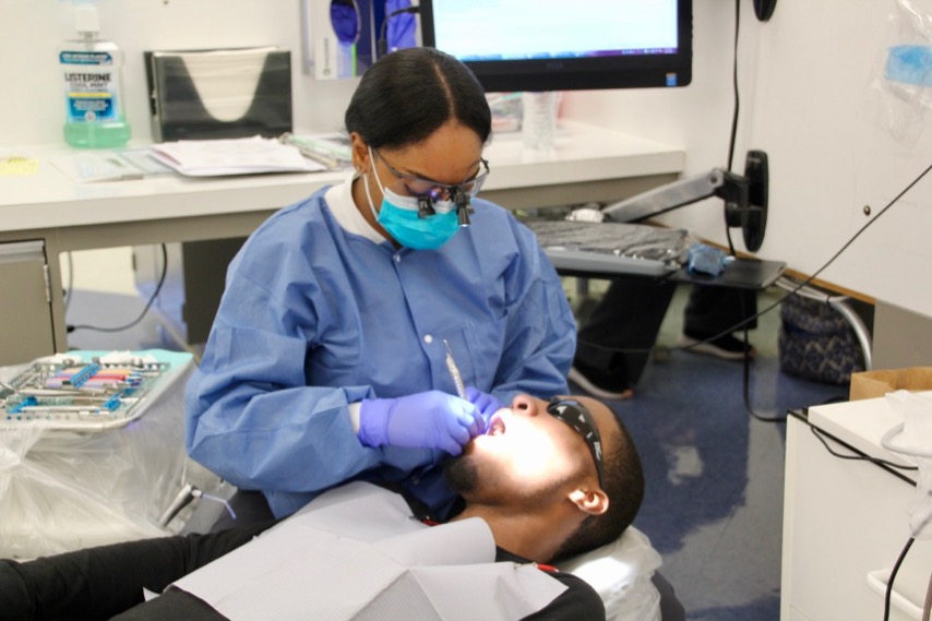 Dental hygiene student Okeila Ledgister with patient