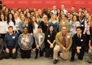 Scholarship winners gather in front of STCC banner