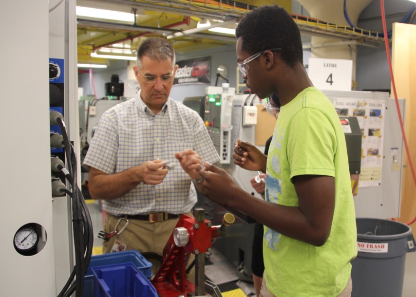 Instructor helps students make fidget spinners