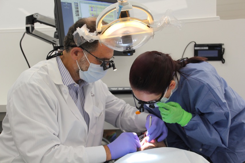 A student assists a dentist at the dental hygiene clinic