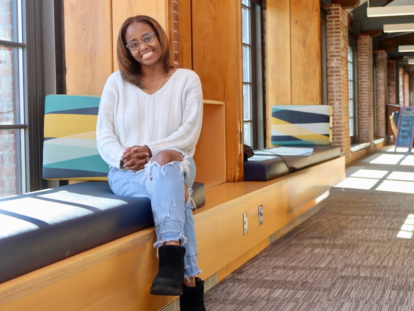 Takira Williams, SGA president 2025, in reading room of library
