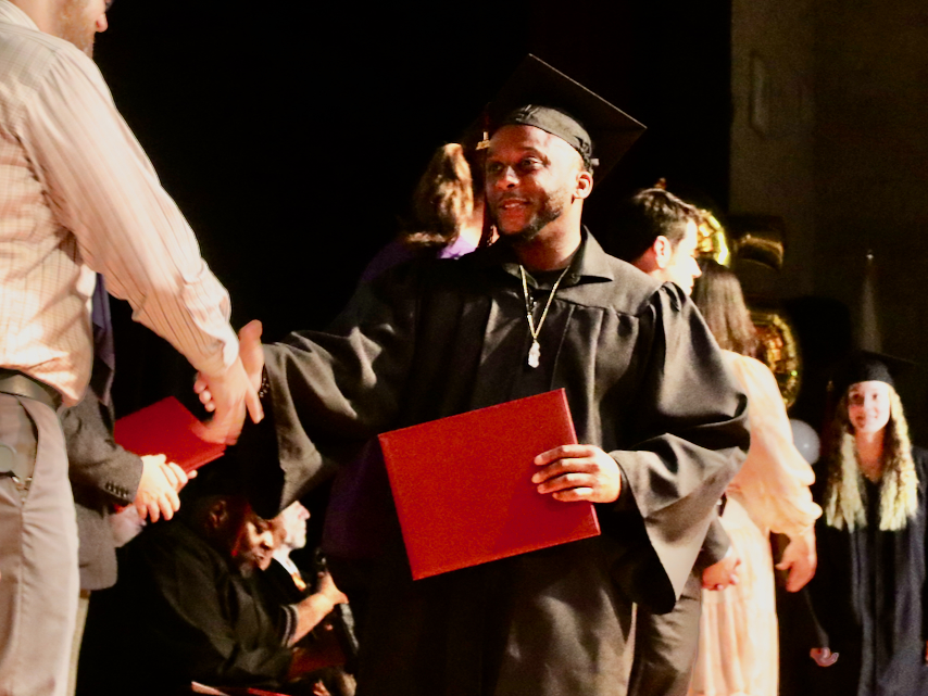 Corey Houston on stage at adult education graduation