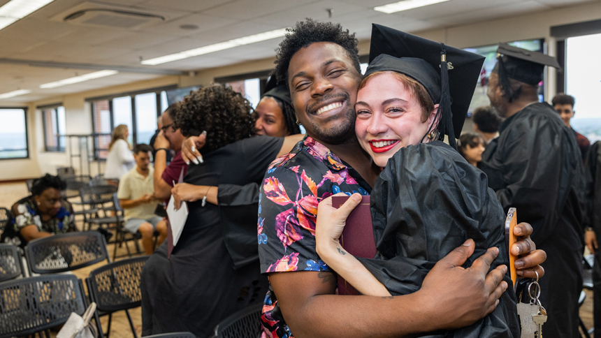 HiSET Graduate hugging significant other