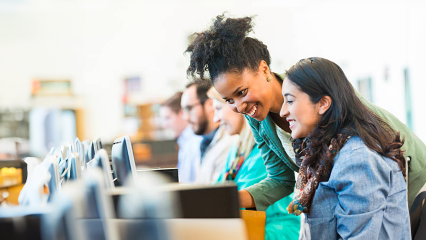 Student at computer with instructor