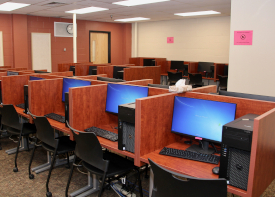 computer lab with wooden dividers between computers