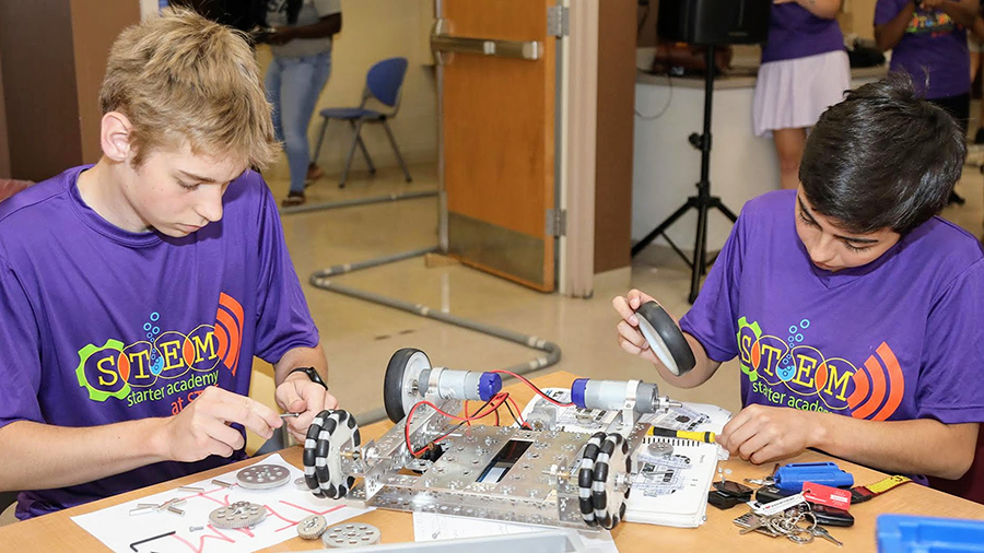 young participants assembling a robot together