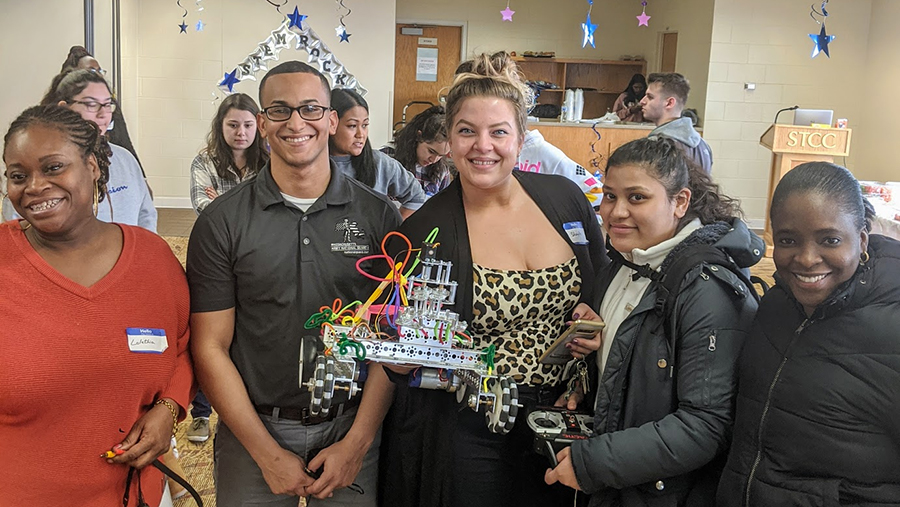 coding and robotics team holding robot