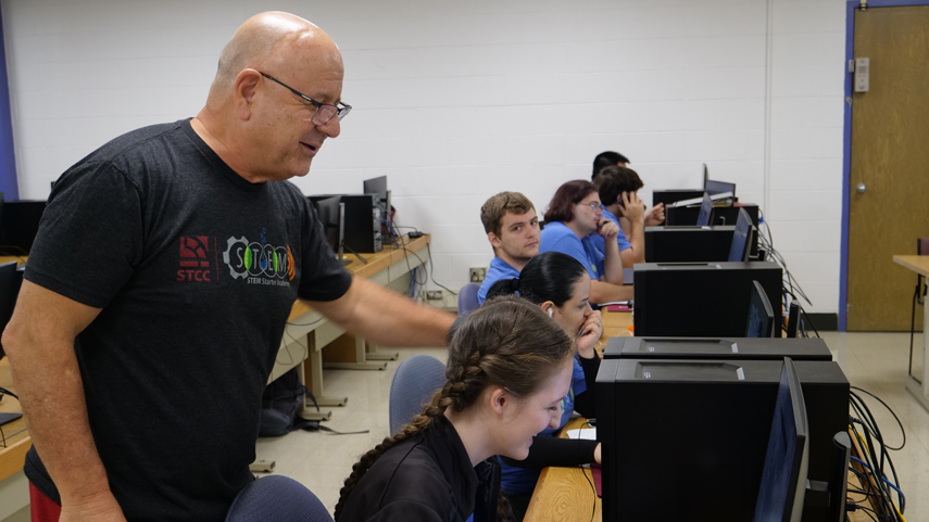 Summer Bridge instructor helping student at computer